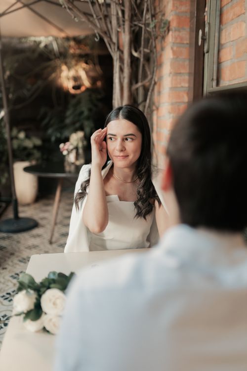 Free Young couple enjoying a romantic date at a charming café with cozy ambiance. Stock Photo