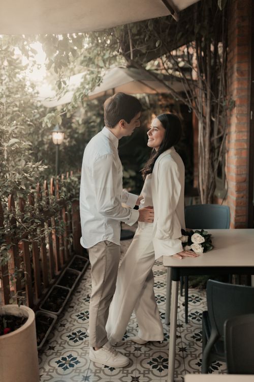 Free Happy couple sharing a romantic moment outdoors in a charming garden setting. Stock Photo