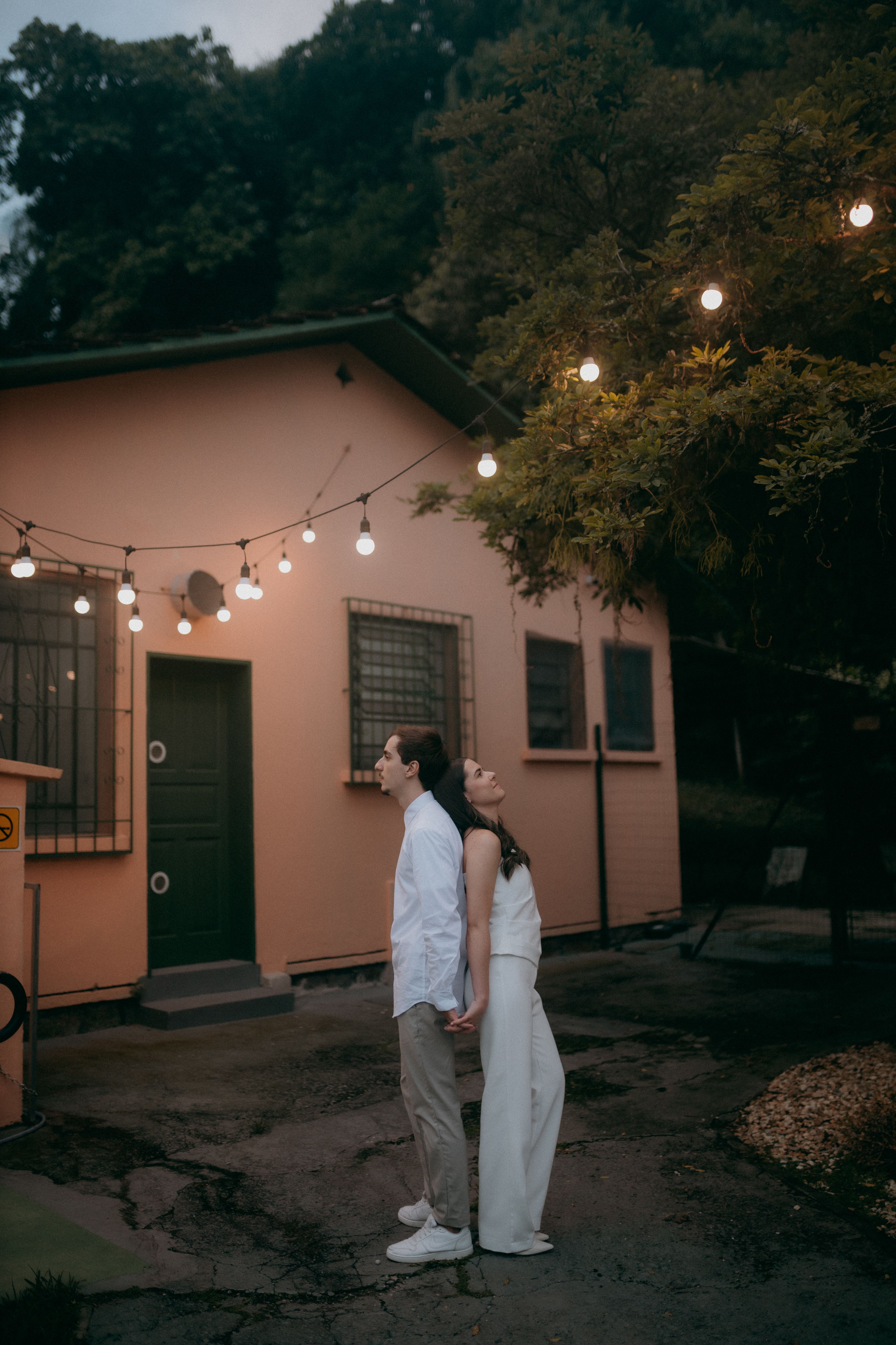 Romantic Couple Under String Lights Outdoors · Free Stock Photo