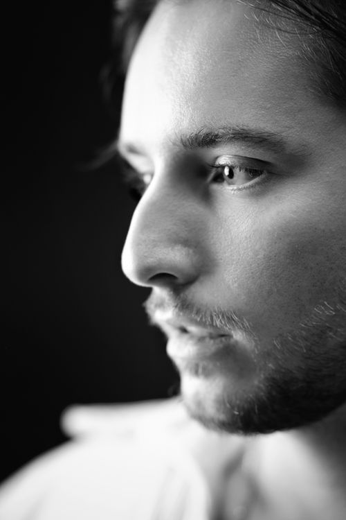 Free Black and white close-up portrait of a young man with a contemplative expression. Stock Photo