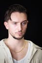 Portrait of a Pensive Young Man with Black Background
