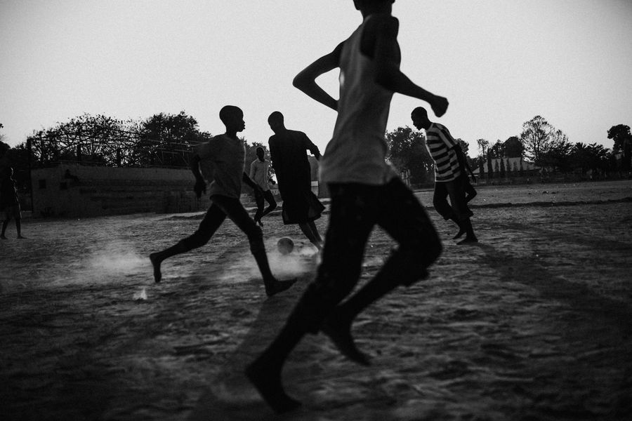 Still frame: players on a dusty pitch at dusk — photo by Kaybee Photography on Pexels
