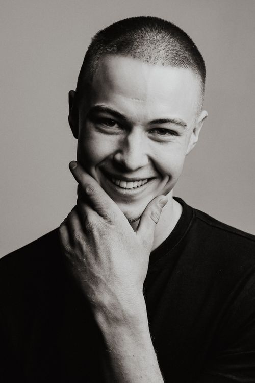 Free Black and white portrait of a smiling young man with short hair, showcasing a genuine expression. Stock Photo