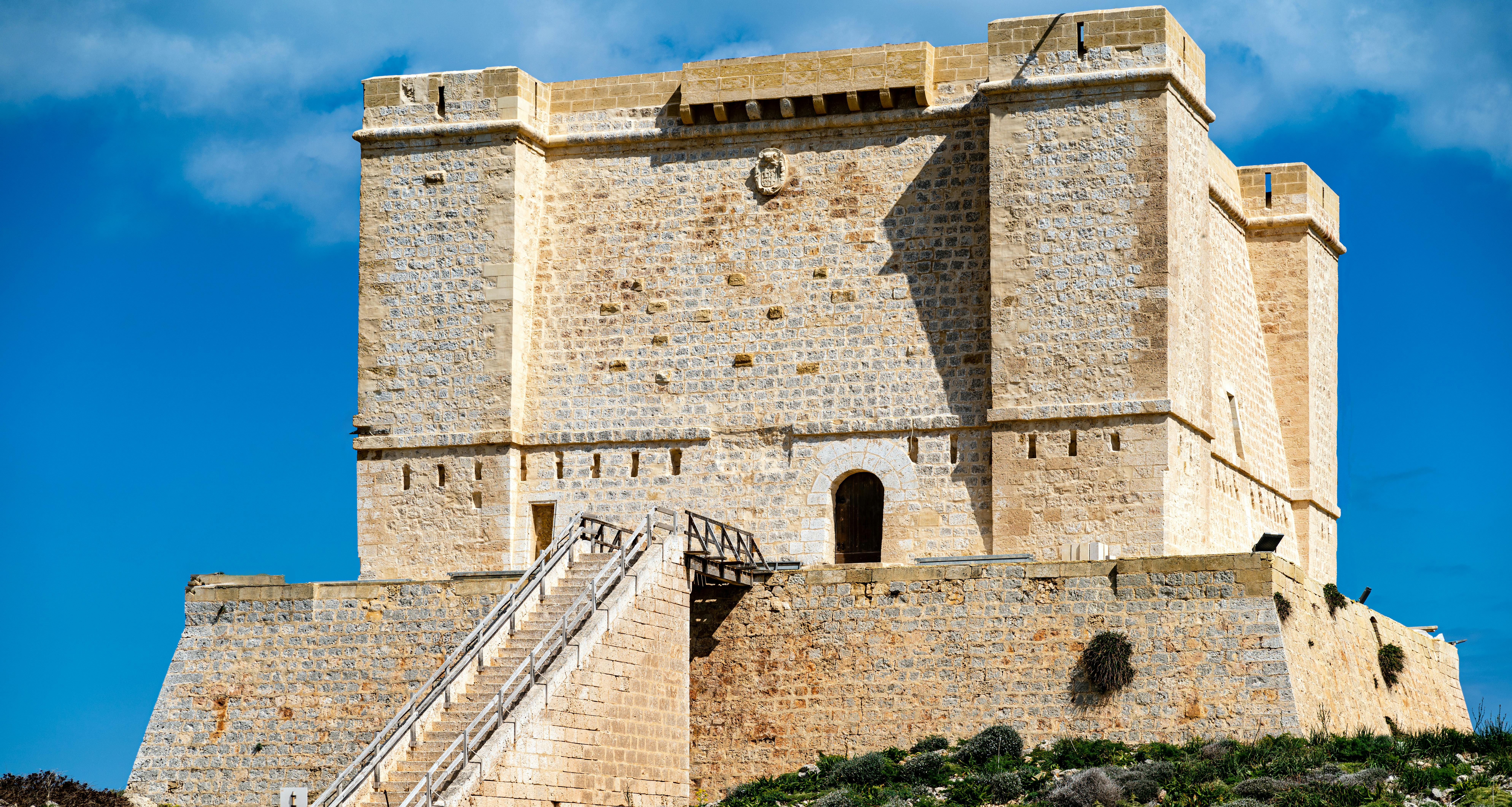 Explore the historic Saint Agatha's Tower in Malta's clear summer sky.