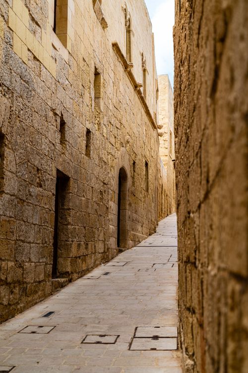 Free Explore the ancient stone alleyways of Malta, showcasing timeless architecture. Stock Photo