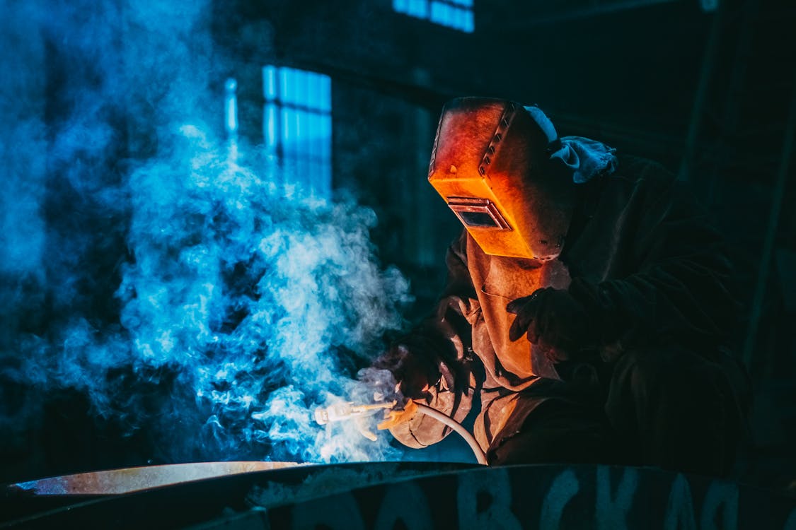 Free Person Welding Wearing a Prootective Metal Mask Stock Photo
