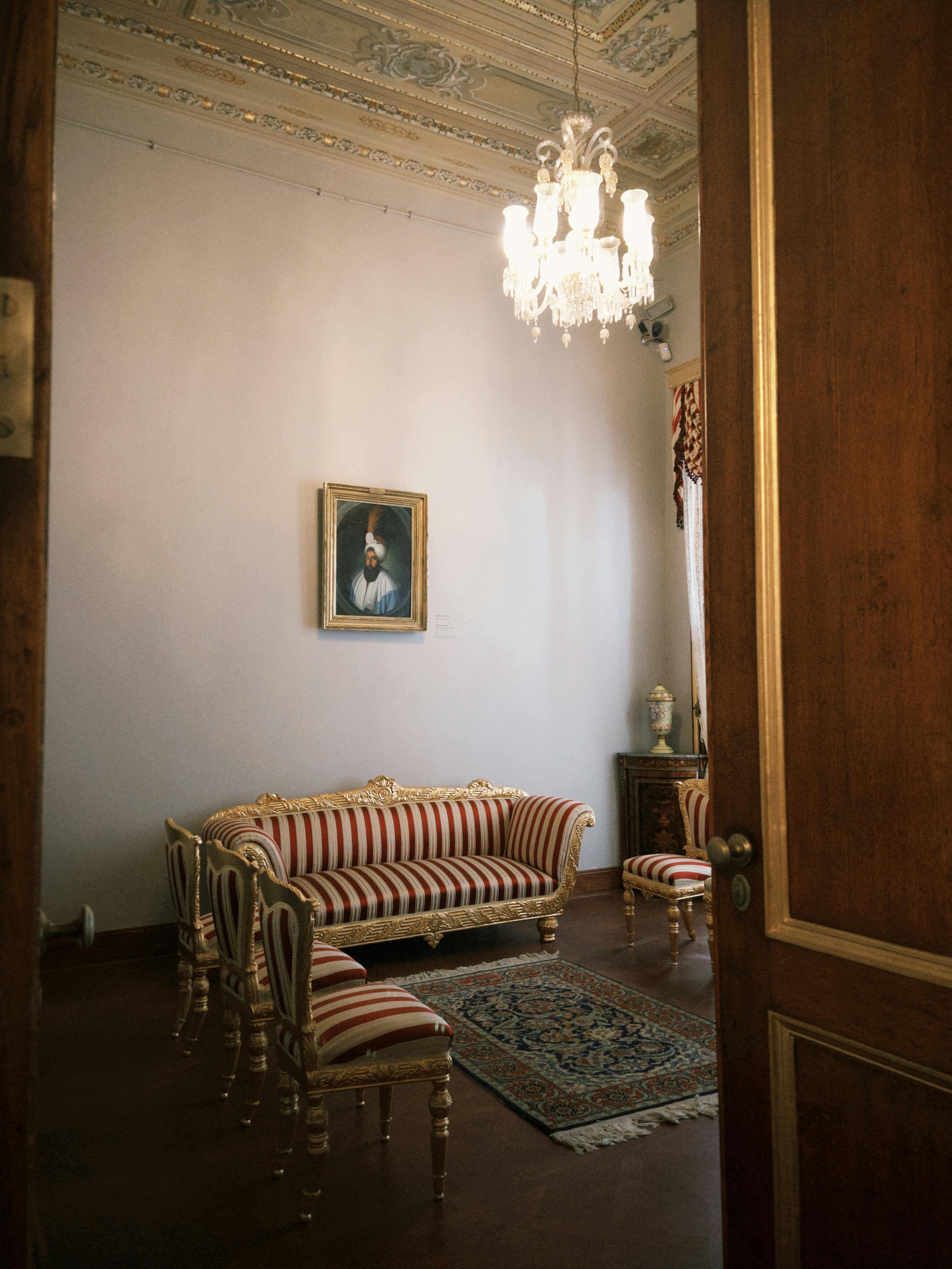 A classic, elegant living room with antique furniture and a chandelier, evoking vintage charm.