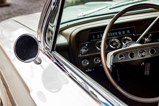 Close-up view of a classic car's dashboard and steering wheel featuring vintage design elements.