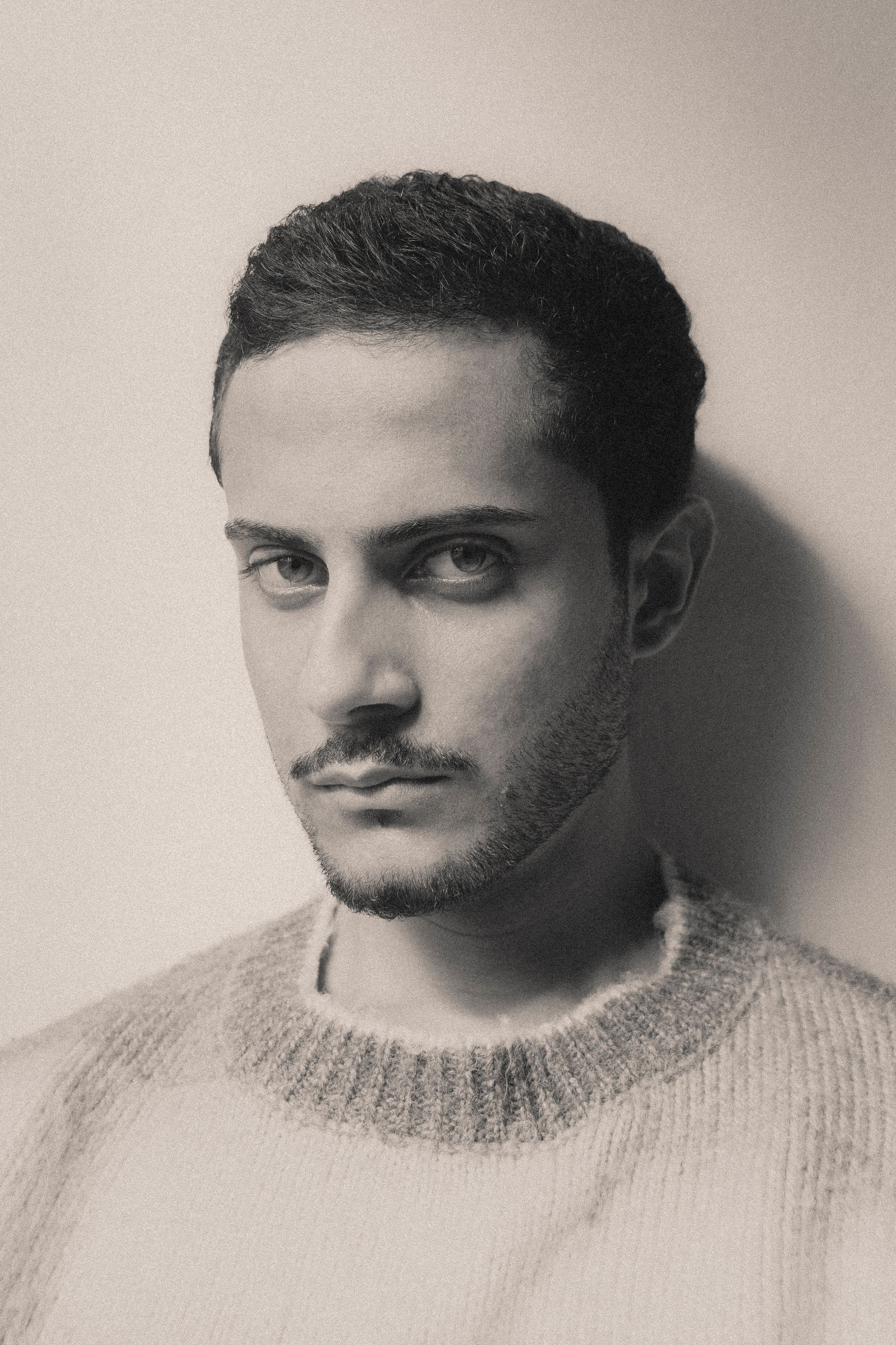 Artistic black and white portrait of a pensive young man.