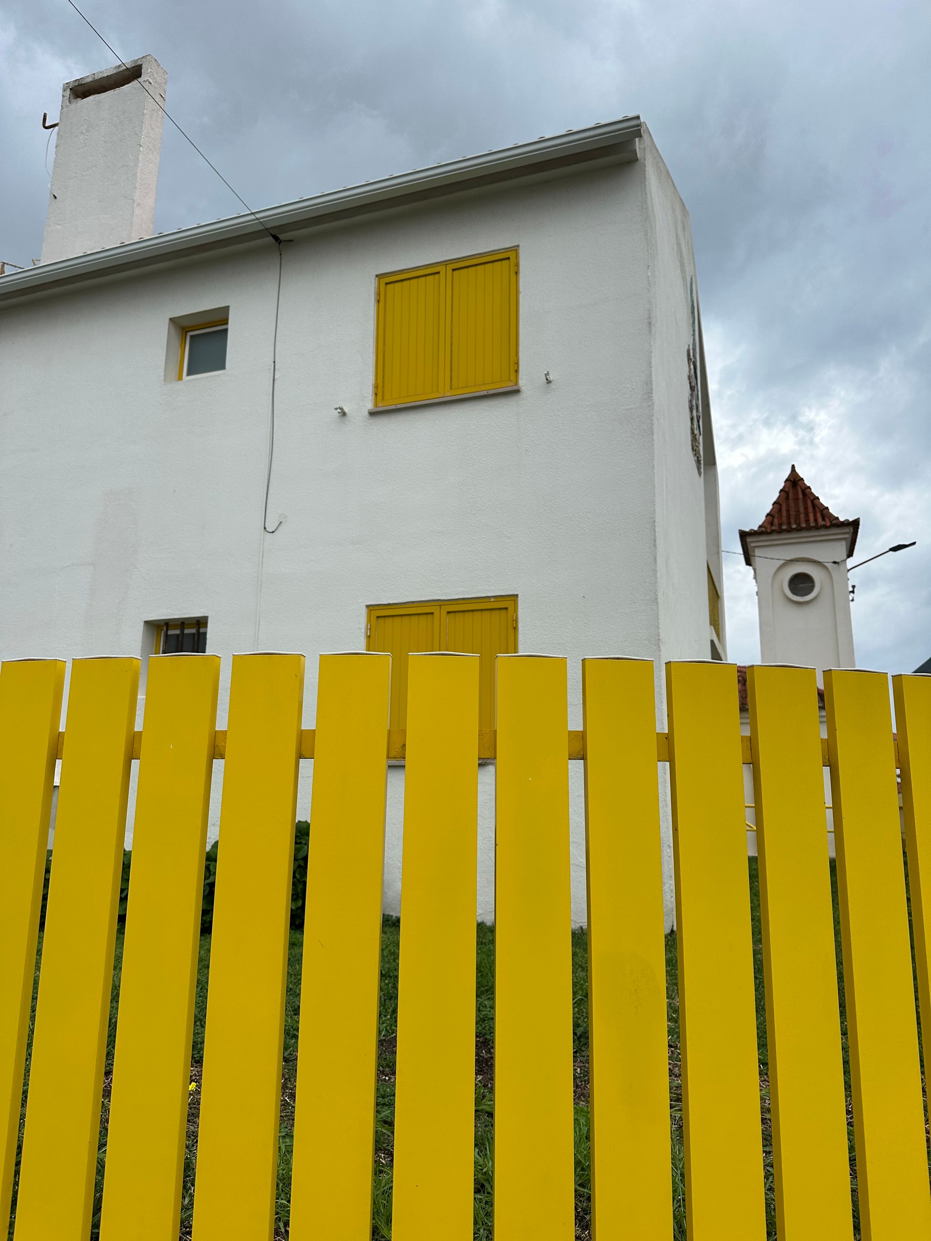 Charming White House with Yellow Fence and Shutters · Free Stock Photo