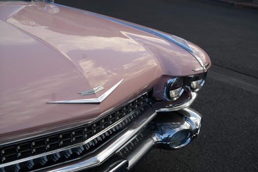A vintage pink Cadillac showcased outdoors in Las Vegas, highlighting its classic design and chrome details.