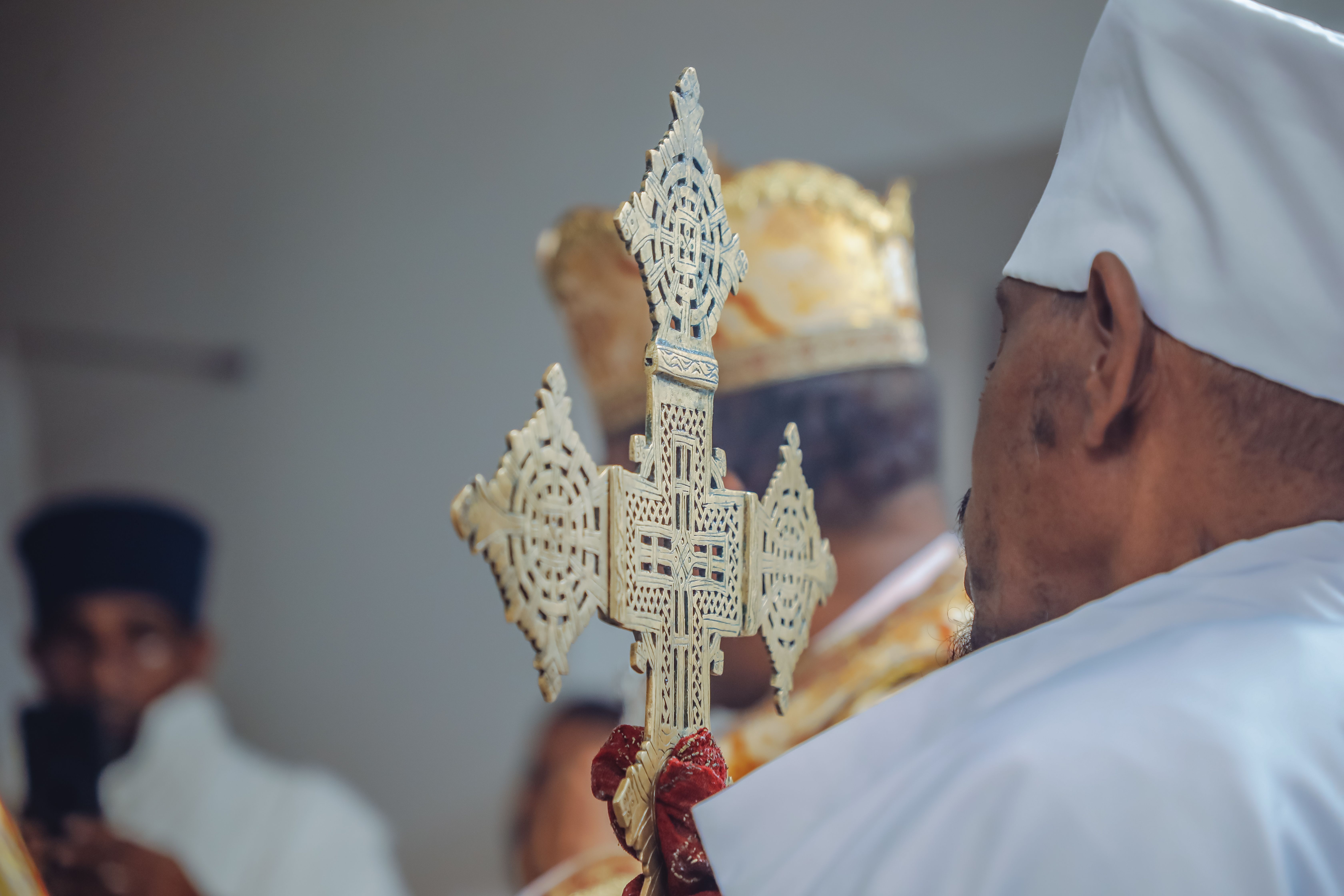 An Ethiopian priest holding an ornate cross during a church ceremony in Addis Ababa, Ethiopia.