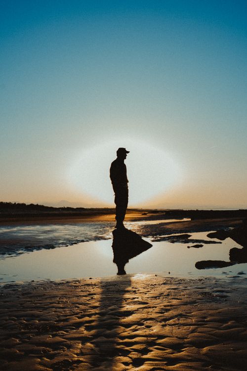 Silhouette of Man at Sunset on Beach · Free Stock Photo
