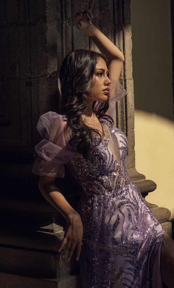Woman wearing a plum draped jersey dress