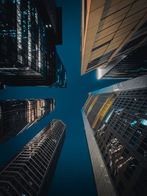 Free Upward view of illuminated skyscrapers at night in Frankfurt, Germany. Stock Photo