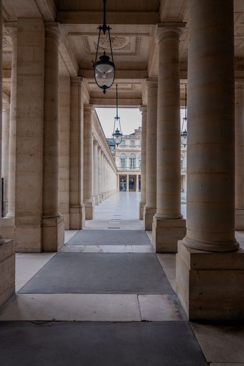 Free Explore the timeless beauty of Parisian architecture through this classic courtyard scene. Stock Photo
