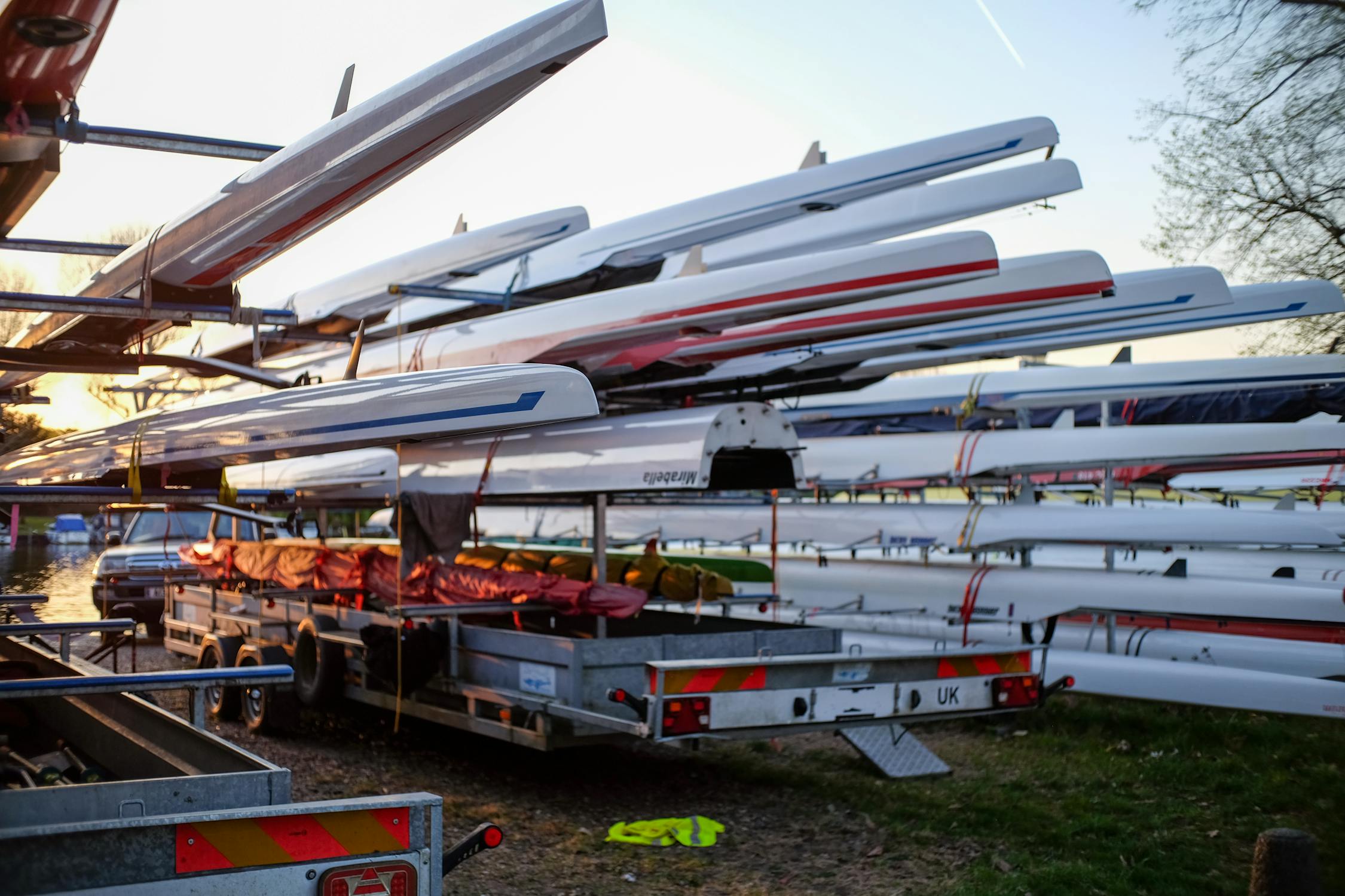 Rowing Sculls on Trailers at Sunset by River · Free Stock Photo