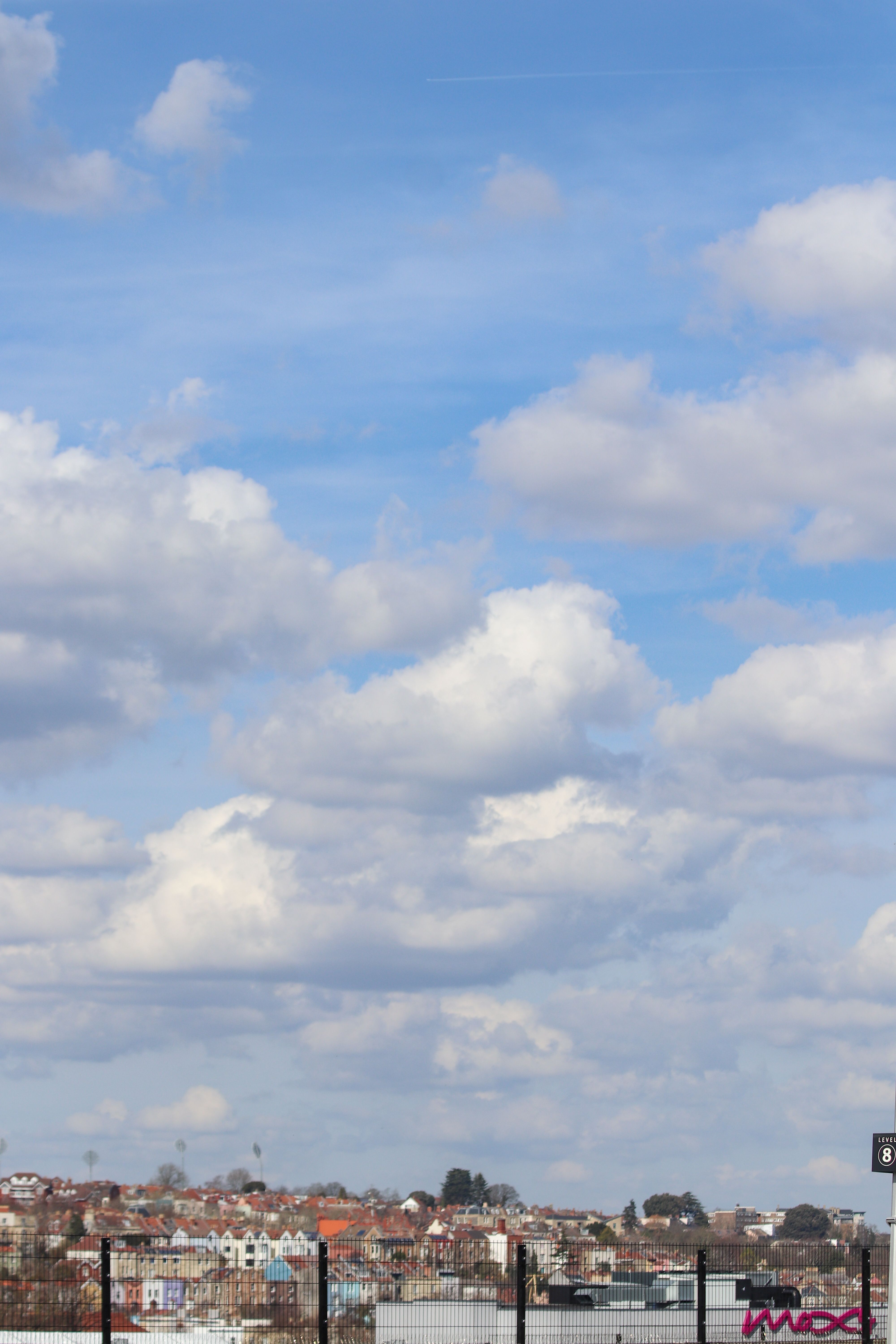 Scenic Cityscape Under Blue Sky with Clouds · Free Stock Photo