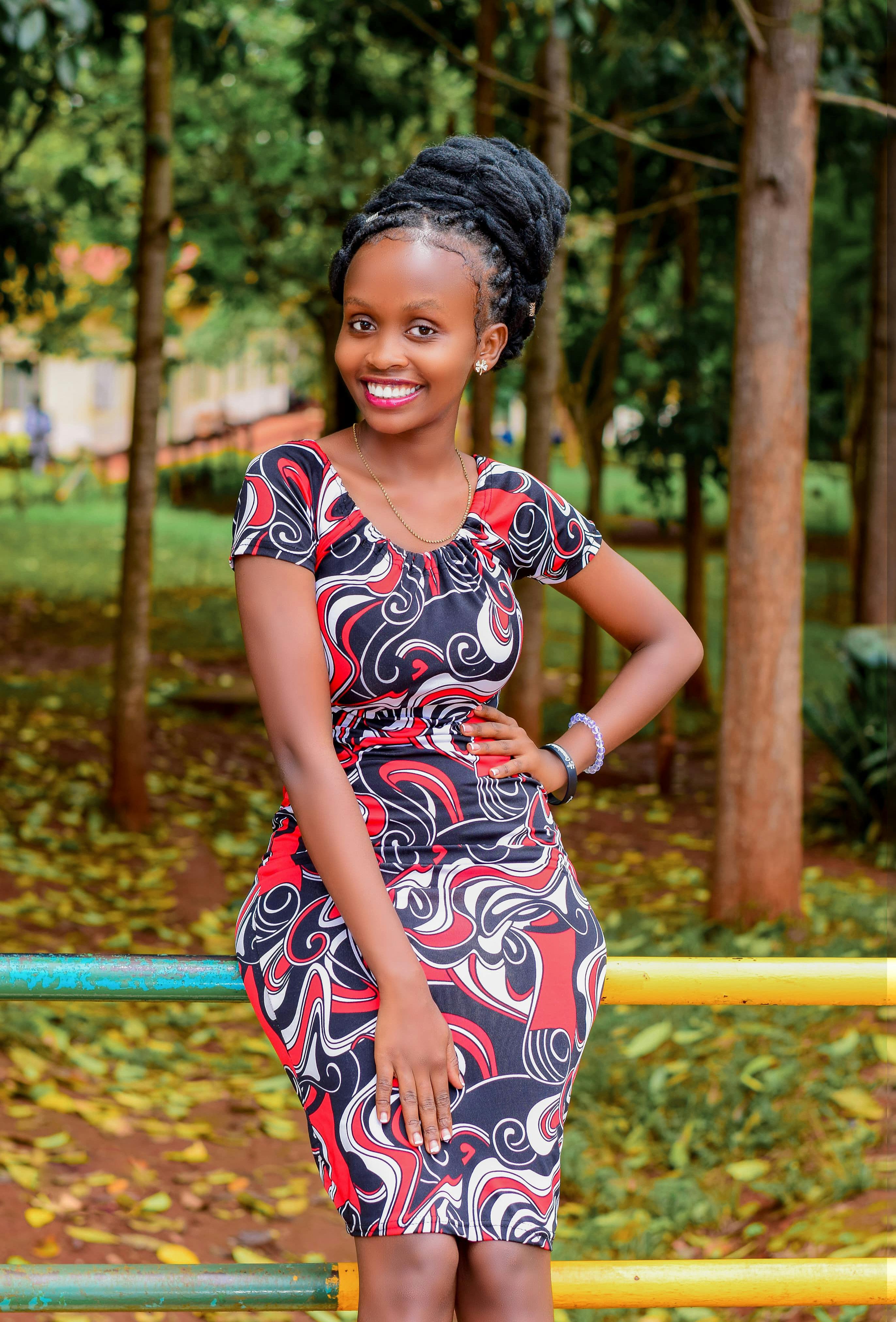 Vibrant portrait of a woman in patterned dress enjoying a day in the park.