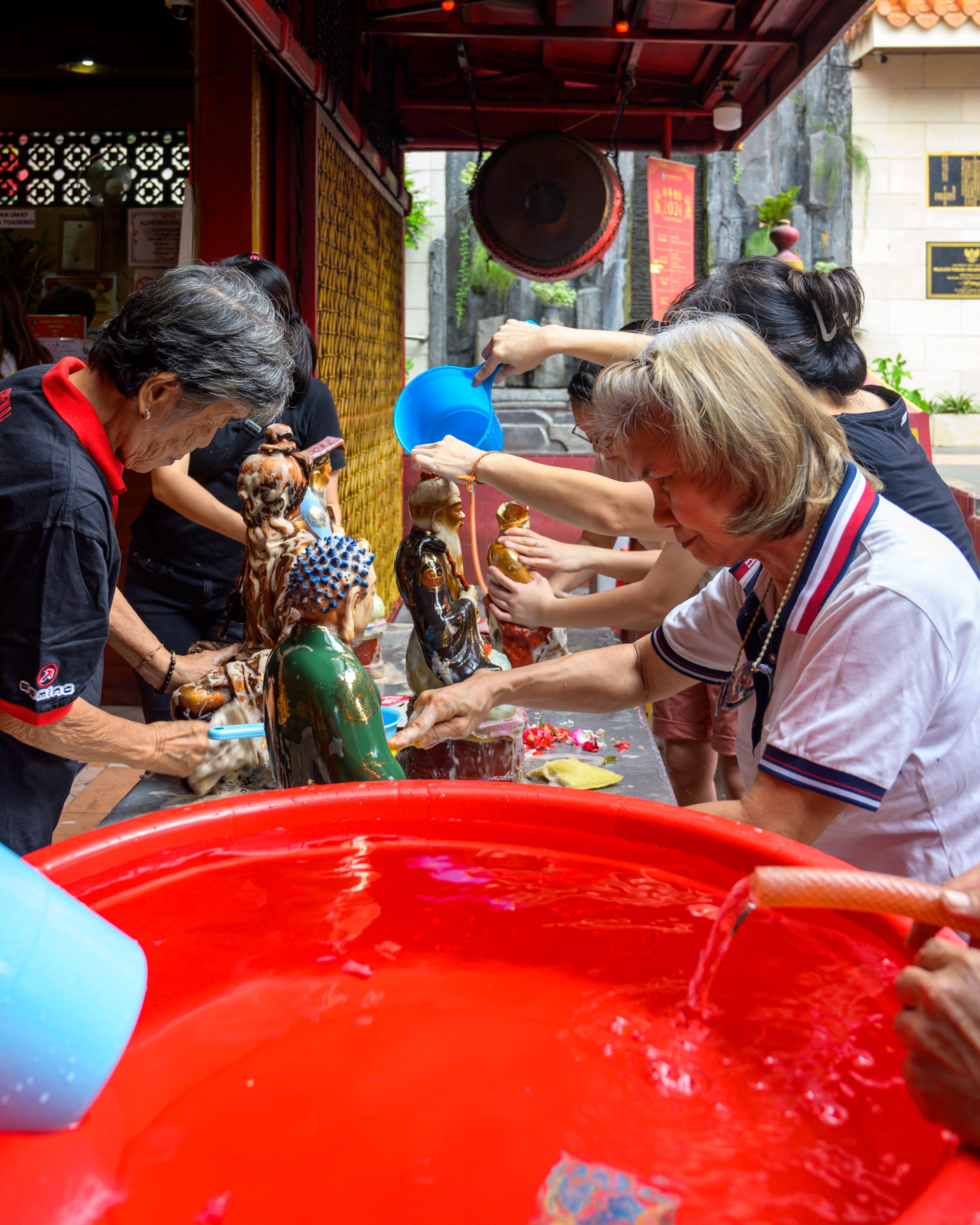 Cultural Ritual in Jakarta: Cleaning Statues · Free Stock Photo