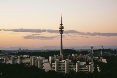 Free Capture of Munich's skyline featuring the prominent Olympia Tower at dusk with a serene sky. Stock Photo