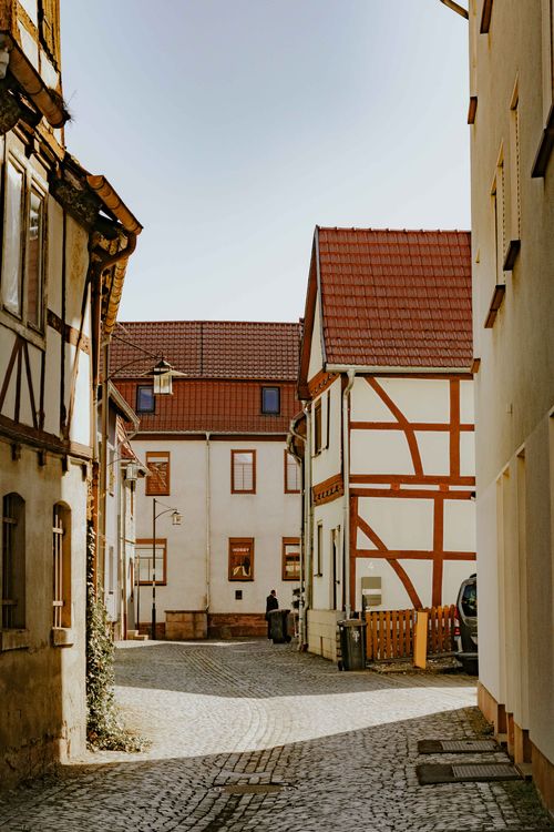 Free Explore the quaint charm of a European town with cobblestone streets and traditional architecture. Stock Photo