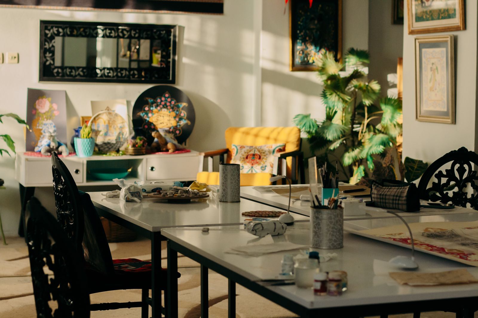 Sunlit studio filled with art supplies and plants — photo by Sedanur Kunuk on Pexels