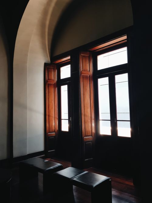 Free A serene interior showcasing classic wooden doors and ambient light for architectural beauty. Stock Photo