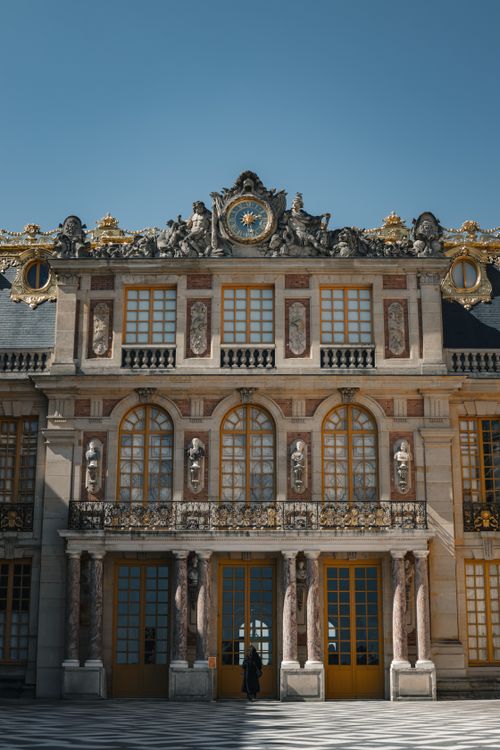 Free Stunning view of the ornate Versailles Palace facade with a blue sky backdrop. Stock Photo