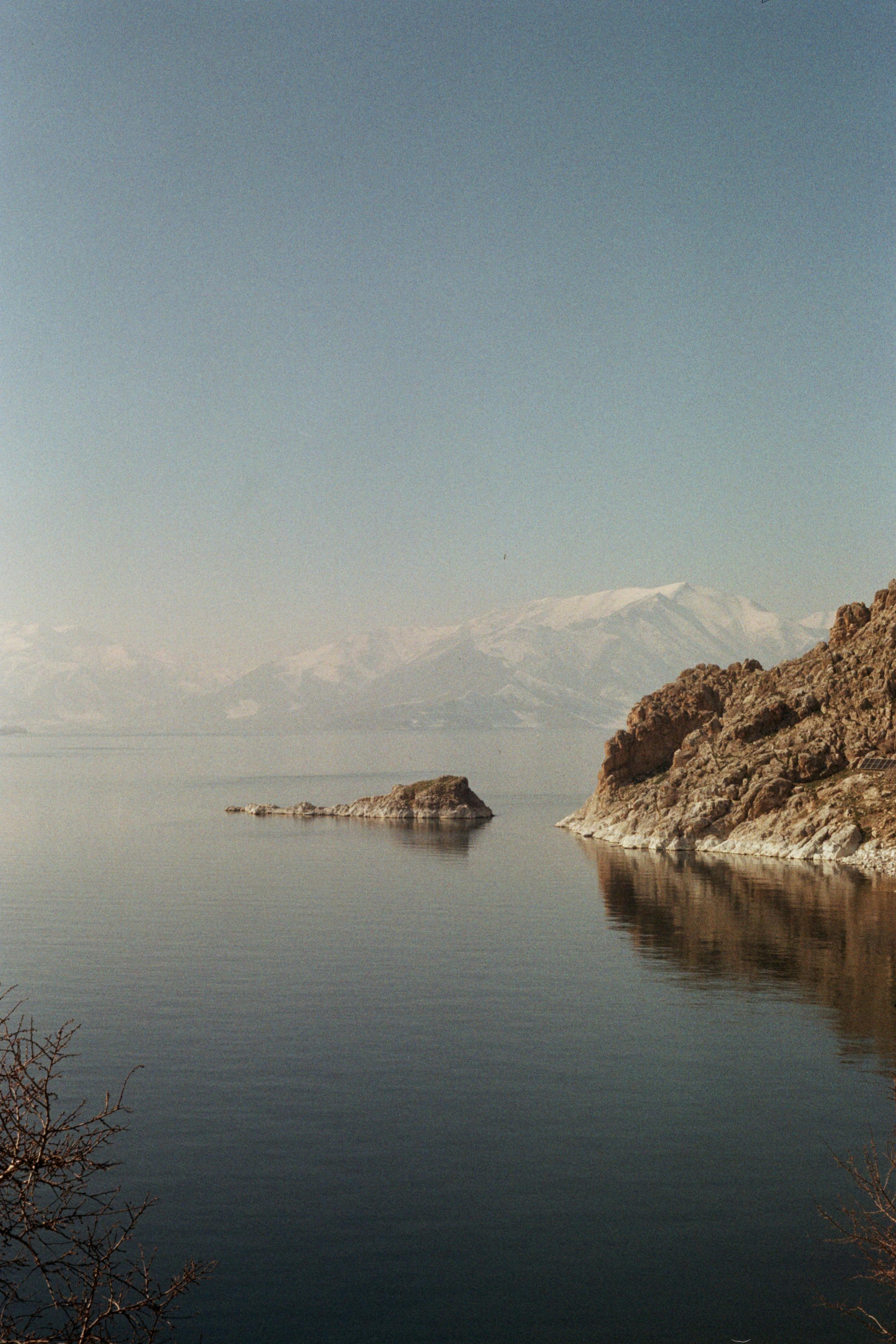 A tranquil view of Lake Van during winter with snow-covered mountains in Türkiye.