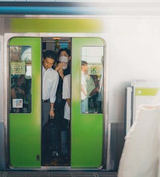 Crowded Yamanote Line train with commuters in Shinjuku, Tokyo, Japan.