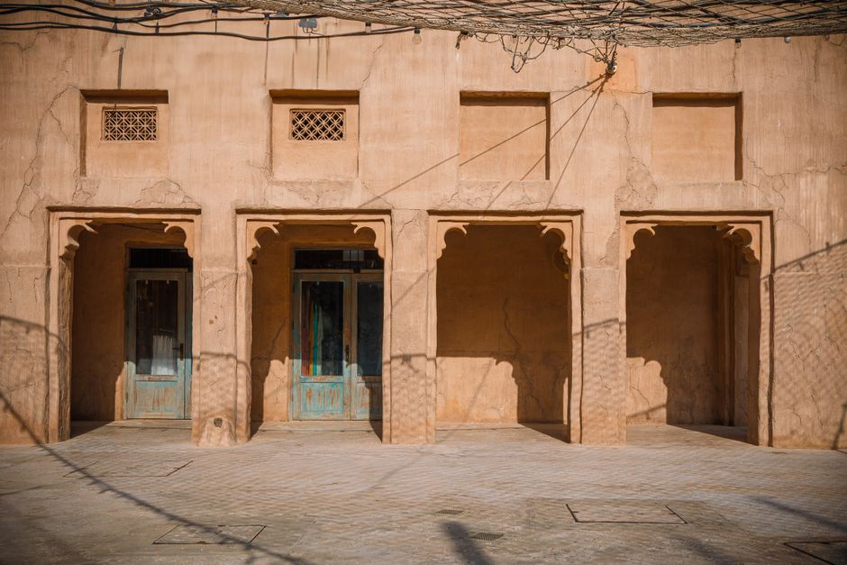 Traditional architecture in Al Fahidi District, Dubai with rustic sandstone walls. Traditional architecture in Al Fahidi District, Dubai with rustic sandstone walls.