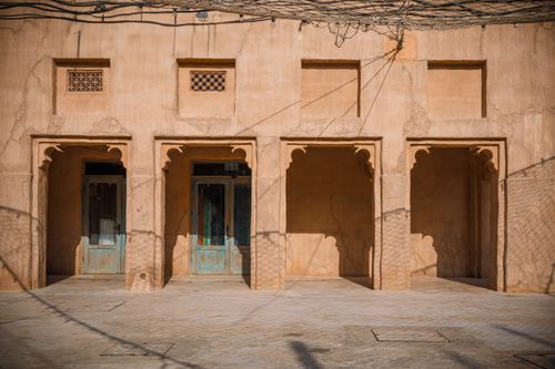 Free Traditional architecture in Al Fahidi District, Dubai with rustic sandstone walls. Stock Photo