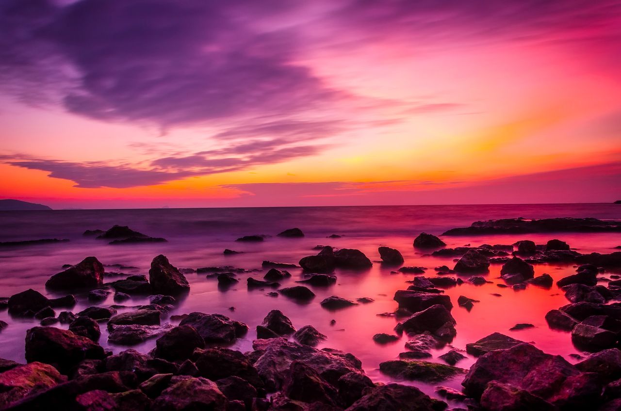beautiful seaside sunset with vibrant pink and orange colors against r