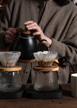 Close-up of artisan brewing process using pour-over technique indoors.