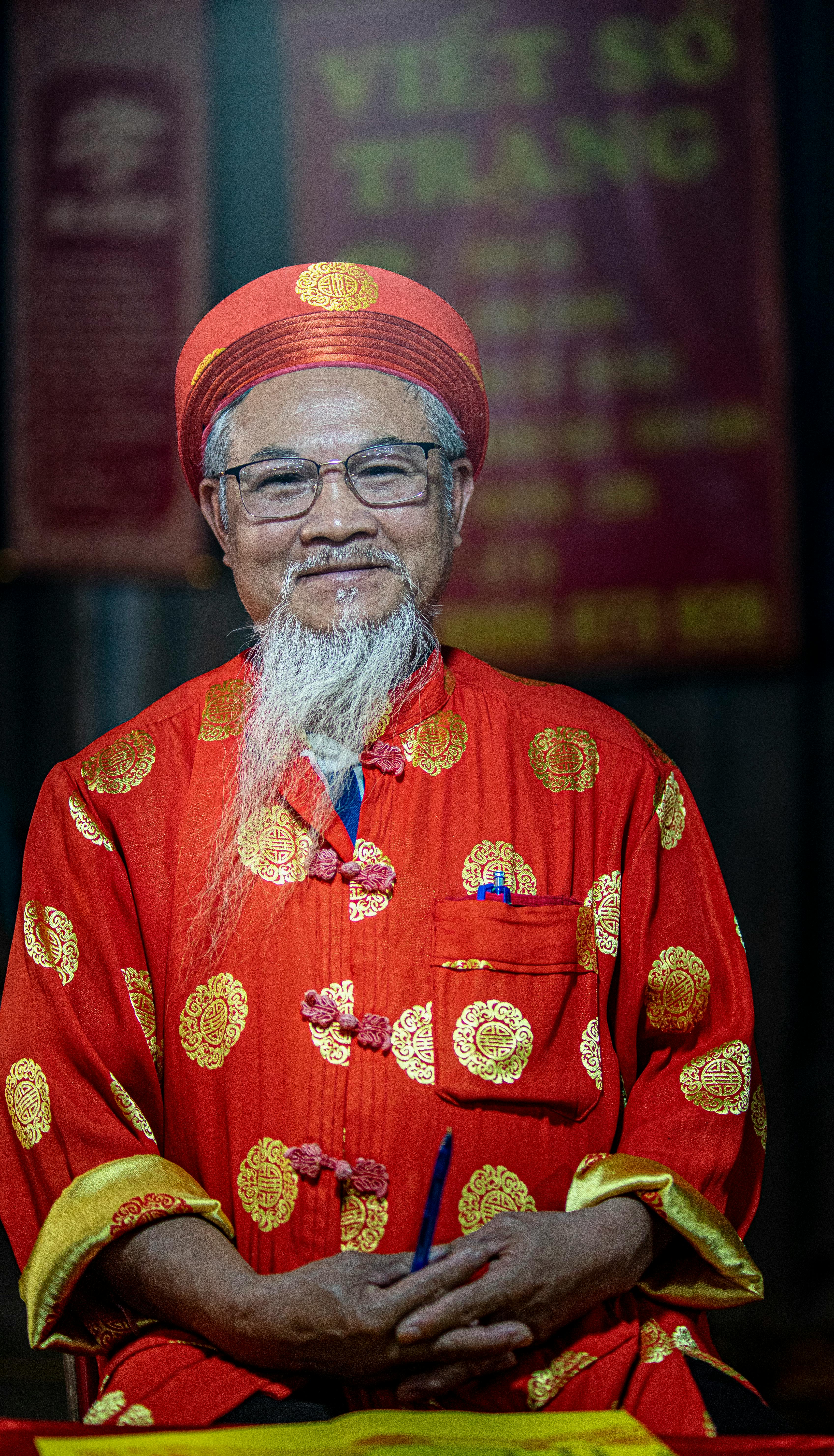 Elderly man in vibrant traditional Vietnamese costume, Hà Nội.