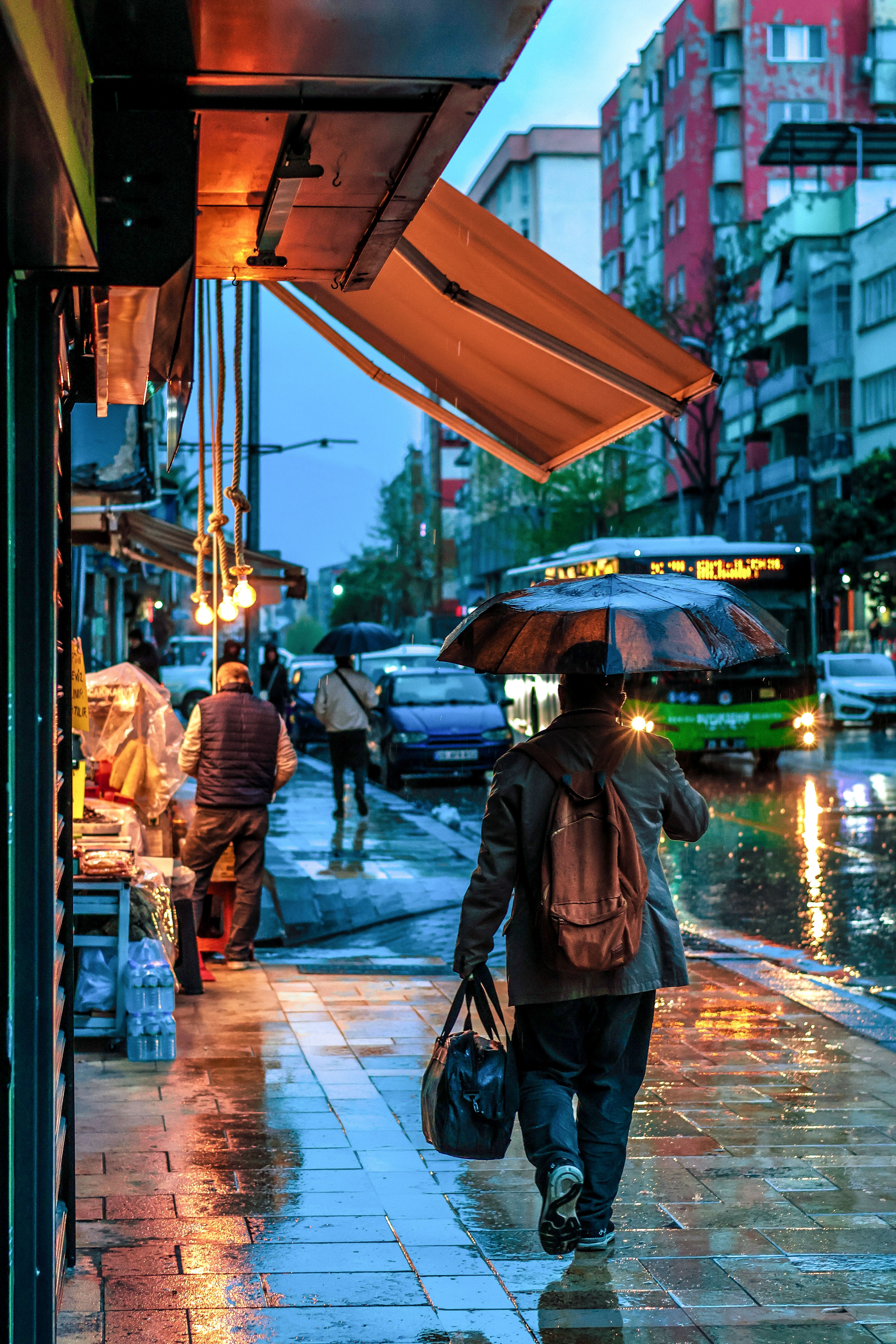 Rainy Urban Street Scene with People Walking · Free Stock Photo