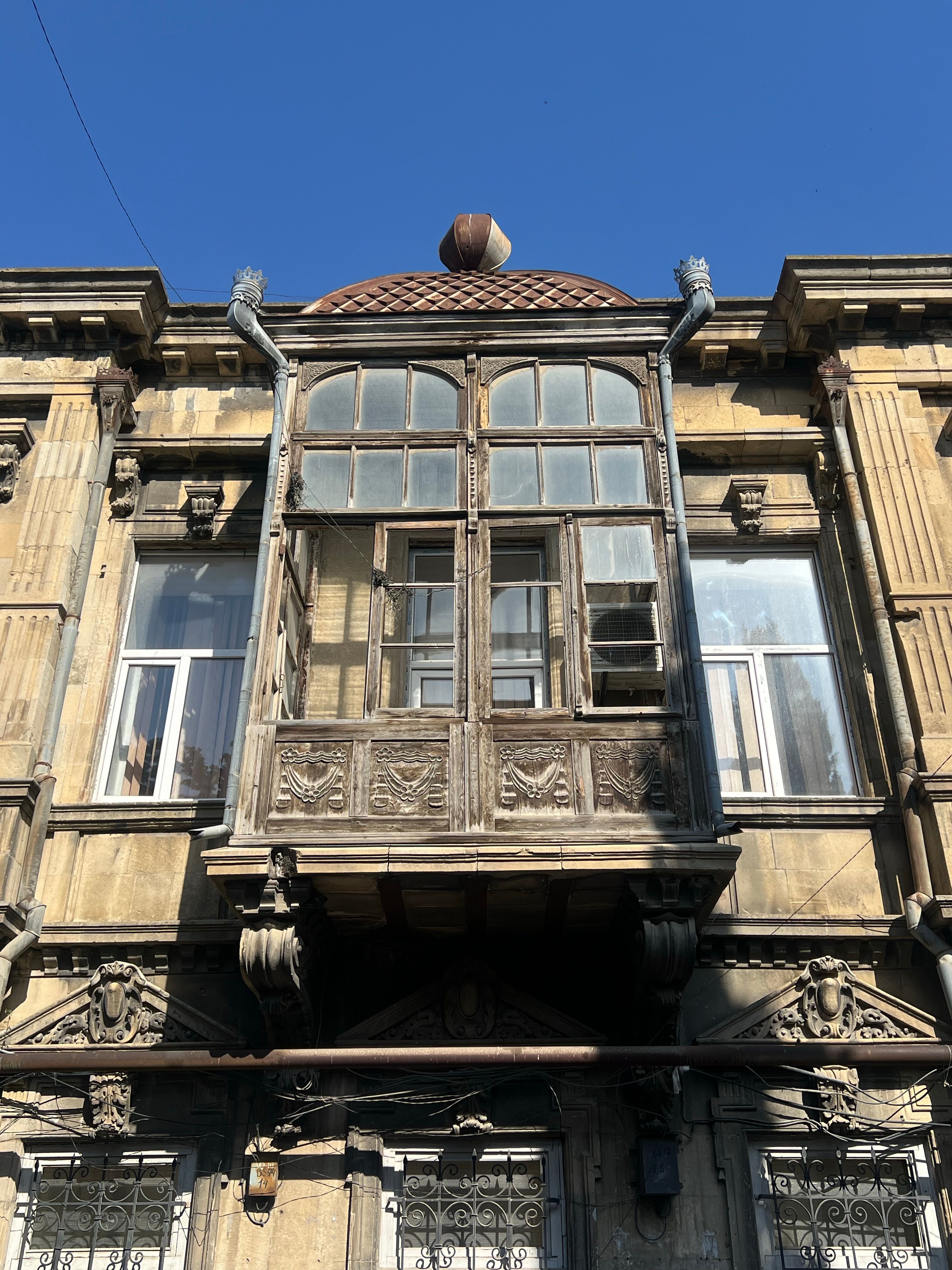 Vintage Architecture with Ornate Wooden Balcony · Free Stock Photo