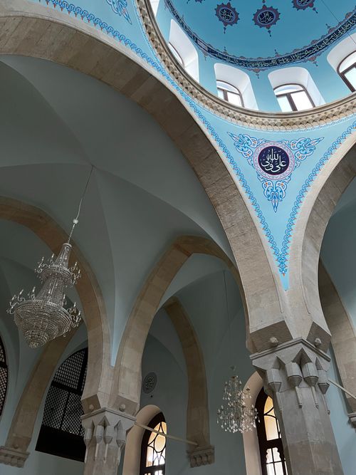 Free Ornate mosque dome with intricate decorations and chandeliers, showcasing Islamic architecture. Stock Photo