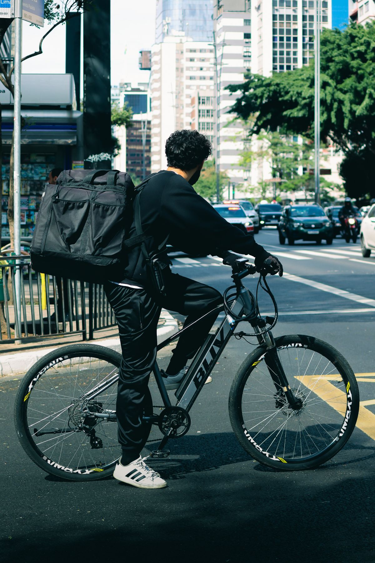 Urban bicycle courier with delivery equipment in a city