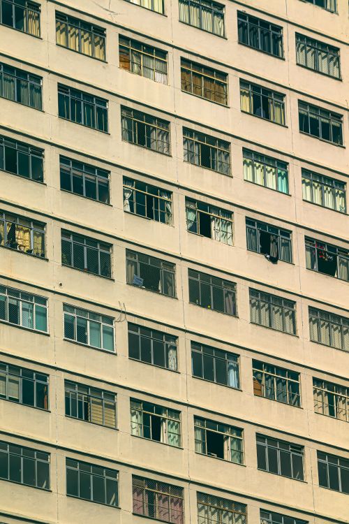Free Diagonal view of a patterned apartment building facade with windows. Stock Photo