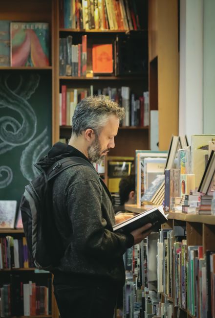 person reading book in a bookstore