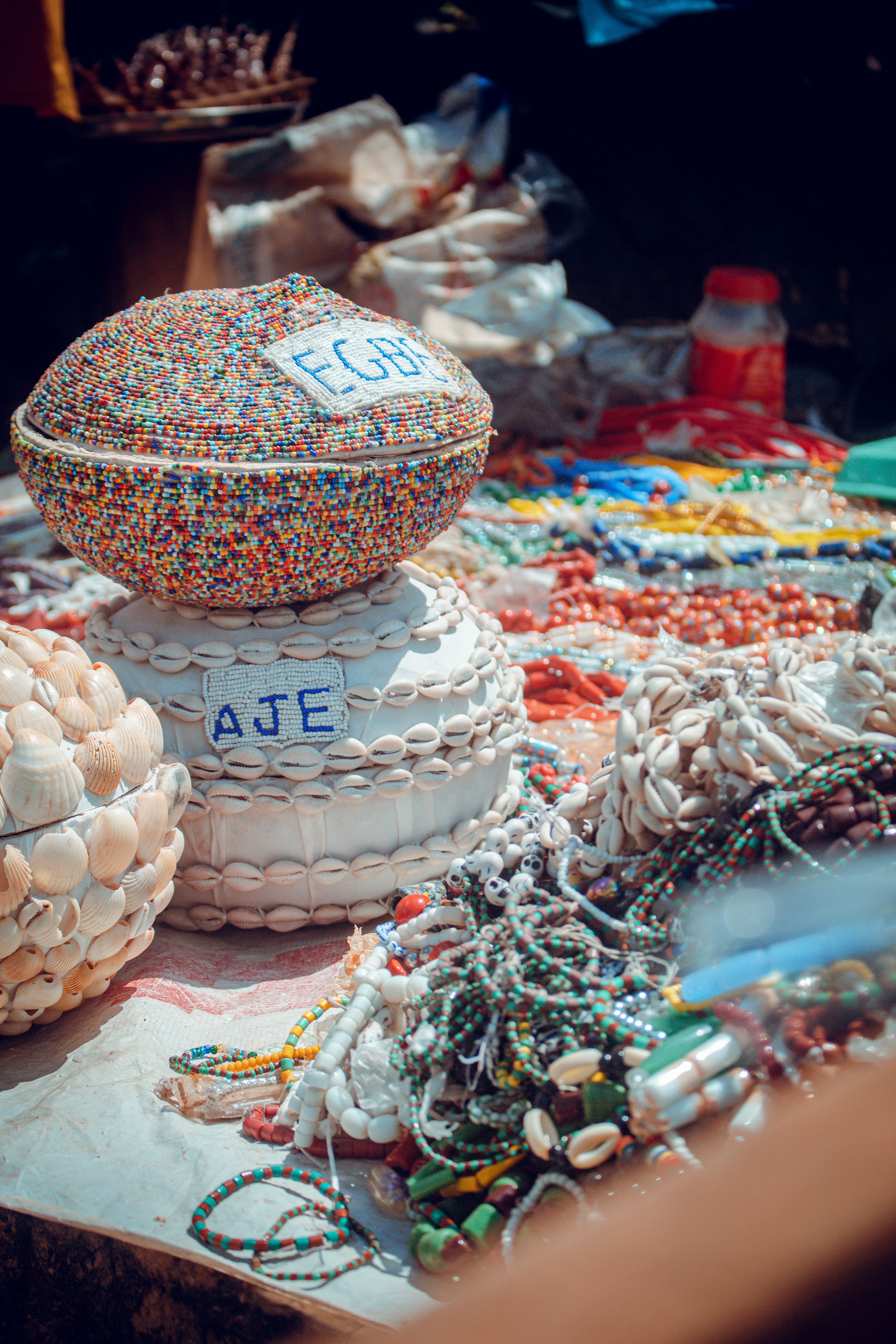 Vibrant display of traditional beads and crafts in Ife, Nigeria market.