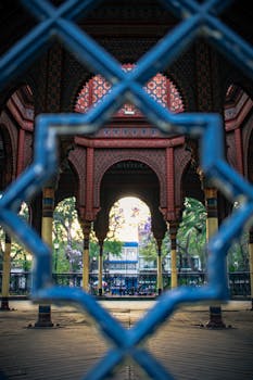 Intricate architectural details of the Kiosko Morisco in Mexico City, captured through a decorative fence.