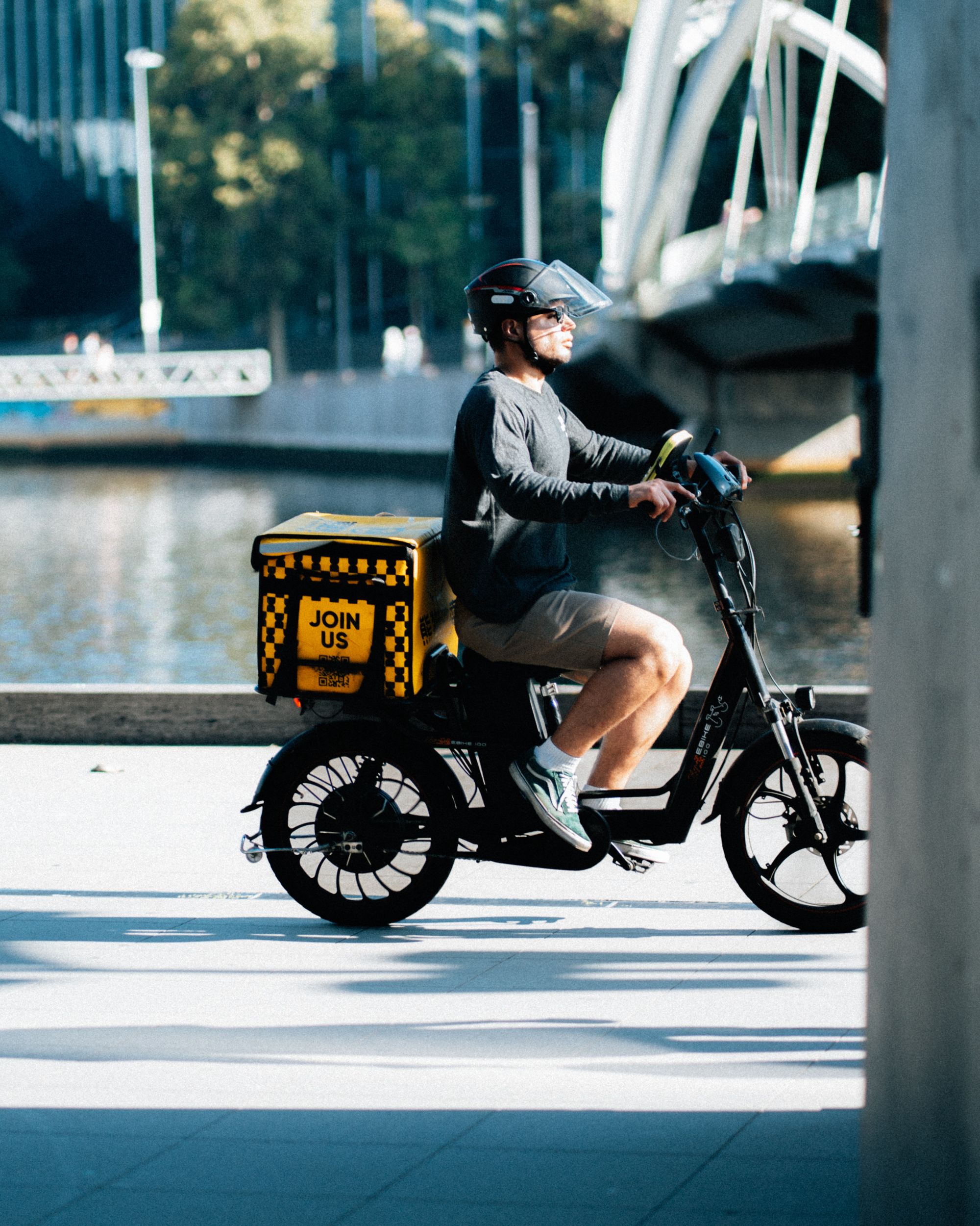 Delivery Rider on Electric Bicycle in Melbourne · Free Stock Photo