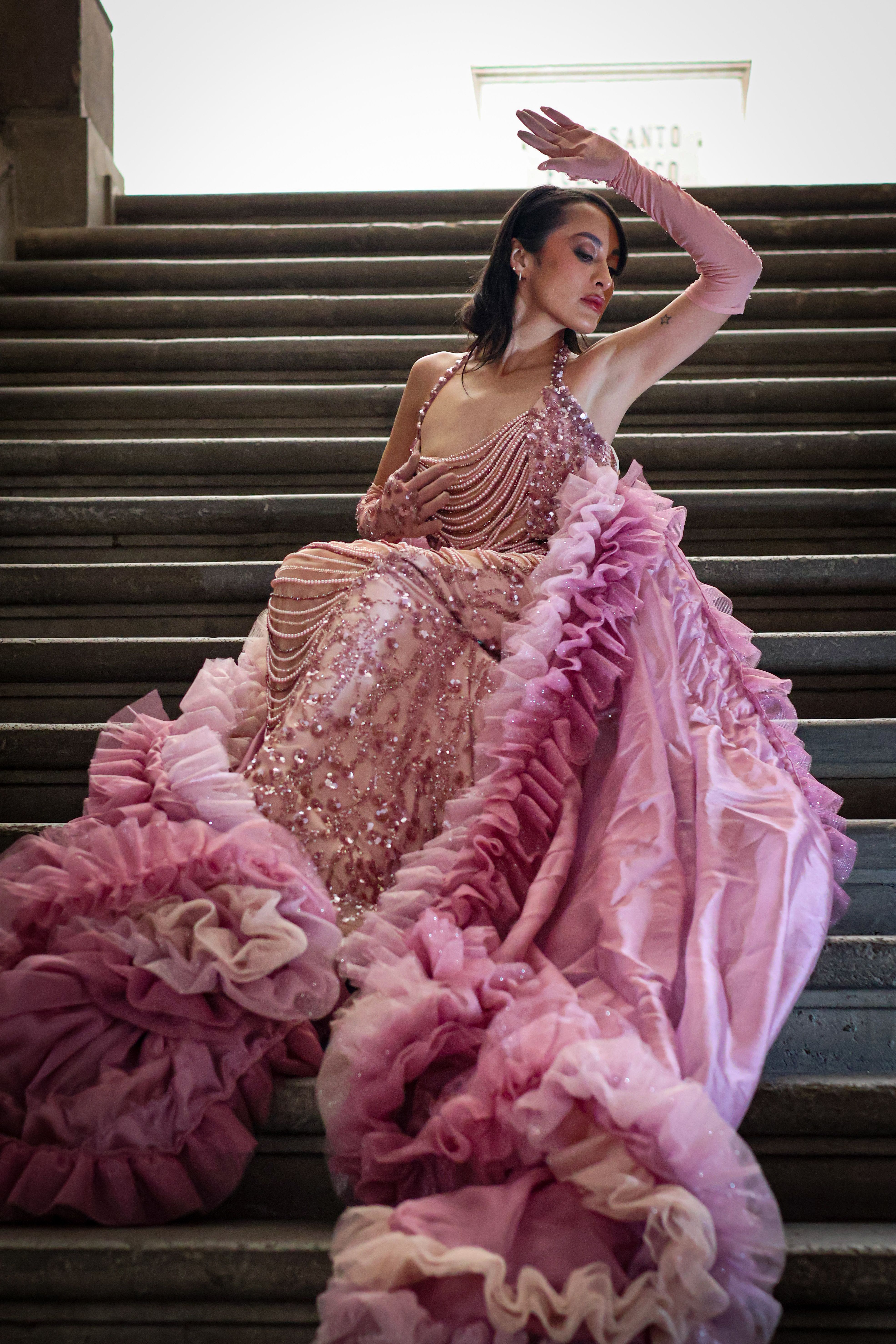 Elegant Woman in Pink Gown on Staircase