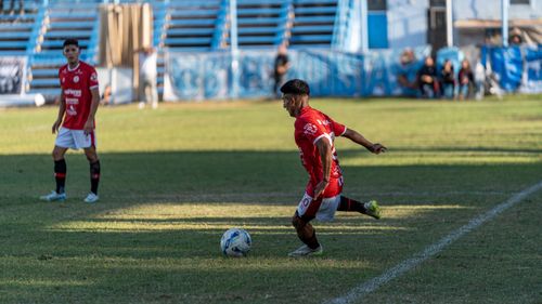 Free Amateur soccer player preparing to kick the ball during a match on a sunny day. Stock Photo