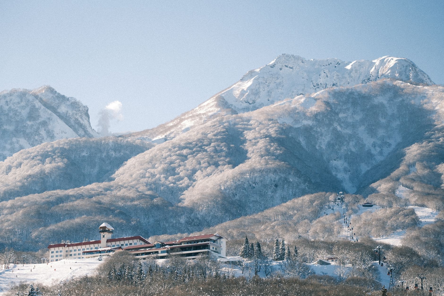 Scenic winter view of a ski resort nestled in the snowy Japanese Alps.