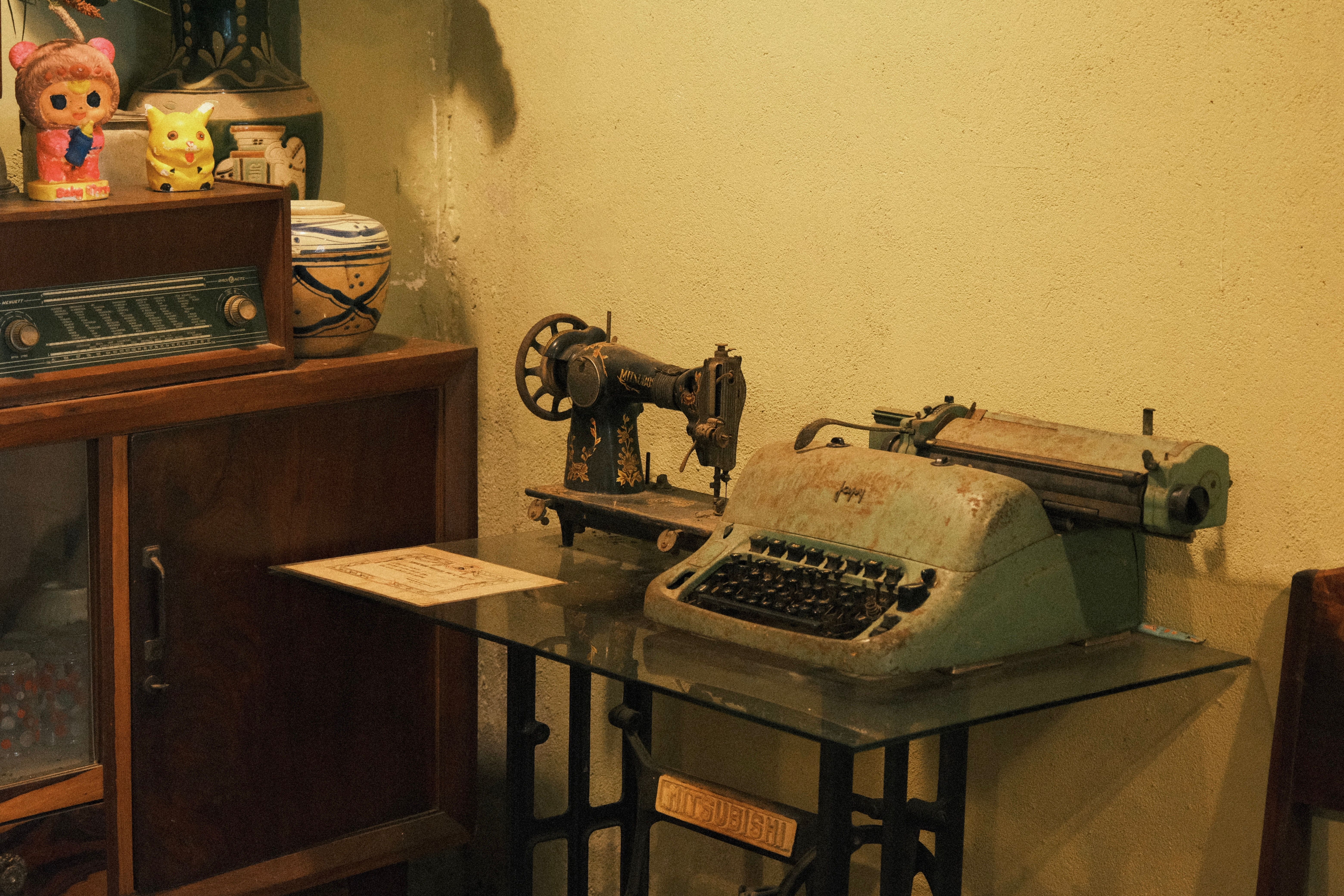 Antique sewing machine and typewriter in a vintage setting