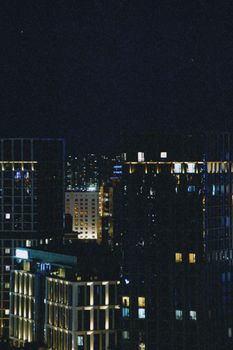 Stunning night view of city buildings in Astana, Kazakhstan, showcasing urban architecture.